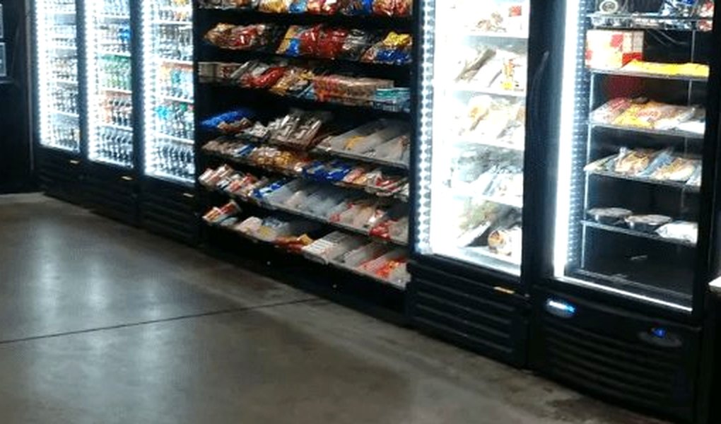 Glass-door smart coolers and a snack rack in a break area
